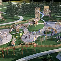 Children's Playground With Wooden Play Structures Slides Climbing Equipment And Green Lawn