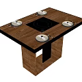 Modern Wooden Dining Table With Central Black Cooktop And Four White Plates