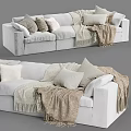 Cozy Light Colored Sectional Sofa with Soft Pillows and Fringed Woven Blankets in Living Room
