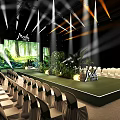 Mova Event Stage Setup With Green Plants Large Screen Lighting And Arranged Chairs