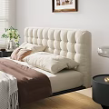 Modern Beige Double Bed with Tufted Headboard Blankets Pillows Nightstands Vase Flowers and Table Lamp