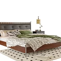 Double Bed With Black Leather Riveted Headboard Green Pillows And Checkered Rug