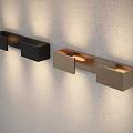Black and Gold Modern Wall Sconces with Soft Illumination on Textured Wall