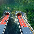 Elevated Road Facilities With Twin Tunnels And Green Mountain Views Featuring Vehicles Driving