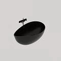 Elegant Black Freestanding Bathtub With Sleek Oval Design And Modern Faucet