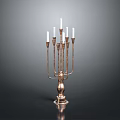 Brass Candelabra With Multiple Arms And White Candles On Black Surface