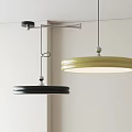 Modern Round Disc Pendant Lights in Black and Yellow Hanging in Interior