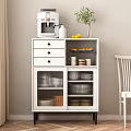 White Sideboard with Drawers and Glass Doors Holding Dinnerware Top Coffee Machine Lemons and Vase