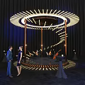 Circular Stage With Ring Lighting And Wooden Supports Near Decorative Tables And People