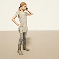 Woman In Striped Dress Jeans And Boots Standing Against Light Background With Hand On Head