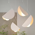 Modern Semicircular Pendant Lights With Textured White Shades And Warm Glow In Minimalist Interior