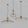 Modern Glass Pendant Lights With Three Different Shapes Illuminated In Minimalist Interior