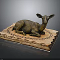 Bronze Deer Sculpture Reclining On Decorative Wooden Base With Intricate Carved Patterns