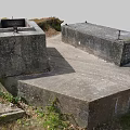Weathered Concrete Structures With Square Openings Rusty Metal And Grassy Mossy Surroundings