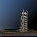 White Tower With Multiple Windows Green Canopies And Wooden Fence Under Blue Sky