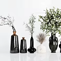 Various Shapes Black White Ceramic Vases With White Flowers Green Foliage And Dried Plants