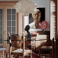 Elegant Dining Room Interior With Wooden Table Chairs Portrait Painting Pink Flowers Glass Door Cabinets And Black Bust Sculpture