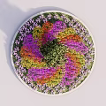 Circular Flower Bed Planter With Central Small Tree And Colorful Surrounding Flowers