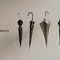 Various Colored Umbrellas Hanging On Light Wall In Stylish Arrangement