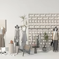 Mannequins Dressed In Stylish Outfits With Hats Bags And Plants In Retail Display Setup
