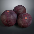 Three Dark Red Round Textured Fruits With Orange Tops On Dark Background