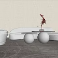 Modern White Curved Sofa and Black Metal Round Coffee Table Set With Decorative Sculpture On Carpet