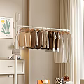 White Clothes Rack with Beige Brown White Tops Blouses and Hanging Small Bag Near Curtain and Wall Art with Plant Design