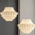 Beige Fabric Pendant Light With Pleated Design Hanging Against Gray Wall