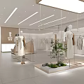 Modern Clothing Store Interior Design With Mannequins Clothing Racks And Decorative Plants
