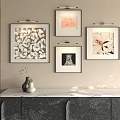Four Abstract Paintings Hanging On Wall With Marble Counter Cabinet And Decorative Vase