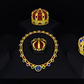 Golden Crowns And Necklace With Red Blue Green Gems On Black Display Stands