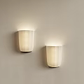 Modern Minimalist Wall Sconces With Cylindrical Design And Soft Lighting On Light Colored Wall 3d model