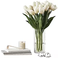 Clear Glass Vase Holding White Tulips With Decorative Candle On Book