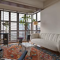 Modern Living Room With Herringbone Flooring Wooden Shutters Beige Sofa And Stone Fireplace