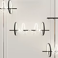 Modern Chandelier With Circular Rings And Glass Globes Hanging In Minimalist Interior Space