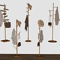 Gold Standing Coat Racks With Hats Scarves Bags Coats Against Light Wall And Wooden Floor