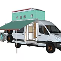 White Van With Green Rooftop Structure And Awning In Outdoor Setting With Trees And Grass