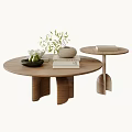 Round Wooden Coffee Table With Unique Leg Design Books Woven Vase And Green Plant