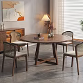 Round Wooden Dining Table Set With Wicker Back Chairs And Light Cushions In Modern Home