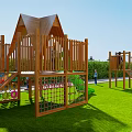 Wooden Playground Equipment With Triangular Roof Slide Climbing Net Colorful Dots On Green Grass