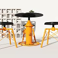 Black Round Table And Chairs With Orange Base Black Seats Magazine And Small Potted Plant