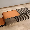 Sleek Modern Coffee Table With Black Metal Wire Frame And Orange Cushioned Top