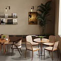 Modern Elegant Cafe Interior With Wooden Tables Chairs Green Plants And Wall Paintings