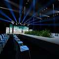 Stage With Blue Lighting Large Screen Seascape View Neatly Arranged White Chairs And Green Plants