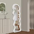 Stylish Wave Shaped Mirror In Light Beige Room With White Cabinet And Potted Plant
