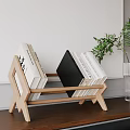 Minimalist Wooden Bookcase With Stacked Books And Green Plant In Glass Vase