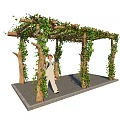 Garden Arbor Covered With Green Vines And People Walking On Stone Path