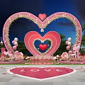 Romantic Pink Heart Shaped Arch Photo Check in Spot with Flowers Balloons and LOVE Sign