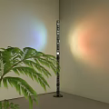Modern Floor Lamp In Interior Corner With Green Fern Plant And Colorful Light Halo