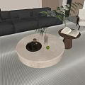 Modern Living Room Interior Featuring Round Coffee Table Grey Sofa Green Plant And Books